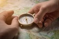 Compass and map in hands of traveler for checking and searching position and direction AI generated