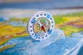 Compass on map. The magnetic compass is located on a geographic map. Satellites adventure. Travel concept.