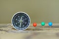 Compass and marking pins on blur vintage world map, journey concept