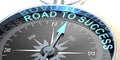 Compass needle pointing to word road to success