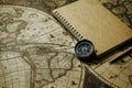 Compass and notebook on blur vintage world map, journey concept, copy Royalty Free Stock Photo