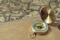 Compass and notebook on blur vintage world map, journey concept, copy space Royalty Free Stock Photo