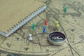 Compass and notebook on blur vintage world map, journey concept, copy space Royalty Free Stock Photo