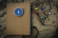 Compass and notebook on blur vintage world map, journey concept, copy space Royalty Free Stock Photo