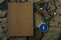 Compass and notebook on blur vintage world map, journey concept, copy space Royalty Free Stock Photo