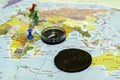 compass and an old copper coin on the geographical map buttons indicate places the concept of treasure hunting treasure Royalty Free Stock Photo
