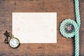 Compass, old paper, pocket watches, rope on wooden desk background Royalty Free Stock Photo