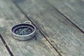 Compass on old wooden table background, journey concept, vintage tone Royalty Free Stock Photo