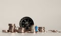 Compass and pile of coins. A miniature old couple. Royalty Free Stock Photo