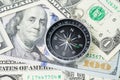 Compass and pile of US dollar money banknote, investment, financial crisis or economic direction concept Royalty Free Stock Photo