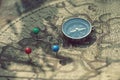 Compass and pin point marking with vintage map background Royalty Free Stock Photo