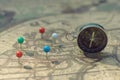 Compass and pin point marking with vintage map background Royalty Free Stock Photo