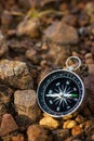 Compass placed on the rock in forest.