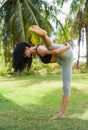 Compass pose variation or Surya Yantrasana yoga with ukrainian woman making it outdoors