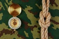 Compass and rope on a camouflage