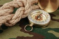 Compass and rope on a camouflage