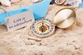 compass in the sand with sign - Life is an adventure Royalty Free Stock Photo