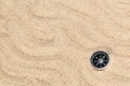 Compass in the sea sand on beach background with copy space for add text message or use components for design. Summer Travel