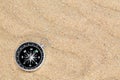 Compass in the sea sand on beach background with copy space for add text message or use components for design. Summer Travel