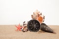 Compass, seastar and seashells in sand closeup Royalty Free Stock Photo