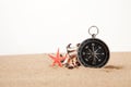 Compass, seastar and seashells in sand closeup Royalty Free Stock Photo