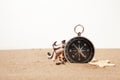 Compass, seastar and seashells in sand closeup Royalty Free Stock Photo