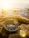 Compass on the shore at sunrise Royalty Free Stock Photo