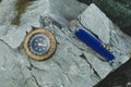Compass and survival knife on granite stone. Royalty Free Stock Photo