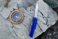 Compass and survival knife on granite stone. Royalty Free Stock Photo