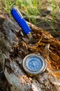 Compass and survival knife on an old rotten stump.A tool for Hiking and survival. Royalty Free Stock Photo