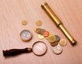 Compass, telescope, magnifier and coin