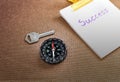 Compass with text success in business concept and key background Royalty Free Stock Photo