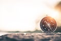 Compass of tourists on mountain at sunset. Royalty Free Stock Photo