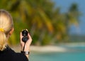 Compass on woman hand against beach landscape