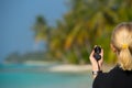 Compass on woman hand against beach landscape Royalty Free Stock Photo