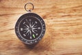 Compass on wooden background with space for text Royalty Free Stock Photo