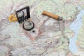 Compass and wooden-handled knife on a hiking map Royalty Free Stock Photo