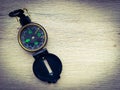 Compass on a wooden surface. Travel background with copy space for text. Royalty Free Stock Photo