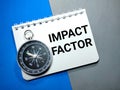 Compass and word IMPACT FACTOR on a blue and gray background. Royalty Free Stock Photo