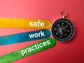 Compass with the words safe work practices on red background Royalty Free Stock Photo