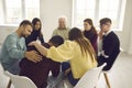Diverse people supporting and comforting a desperate man in a group therapy session Royalty Free Stock Photo