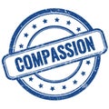 COMPASSION text on blue grungy round rubber stamp