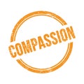 COMPASSION text written on orange grungy round stamp