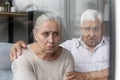 Compassionate old 80s retired man supporting elderly wife. Royalty Free Stock Photo