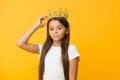 Compelling baby. Kid wear golden crown symbol of princess. Girl cute baby wear crown while stand yellow background Royalty Free Stock Photo