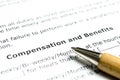 Compensation and benefits with wooden pen Royalty Free Stock Photo