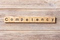 Competency word written on wood block. Competency text on table, concept Royalty Free Stock Photo