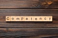 Competency word written on wood block. Competency text on table, concept