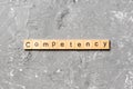 Competency word written on wood block. Competency text on table, concept Royalty Free Stock Photo