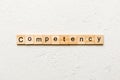 Competency word written on wood block. Competency text on table, concept Royalty Free Stock Photo